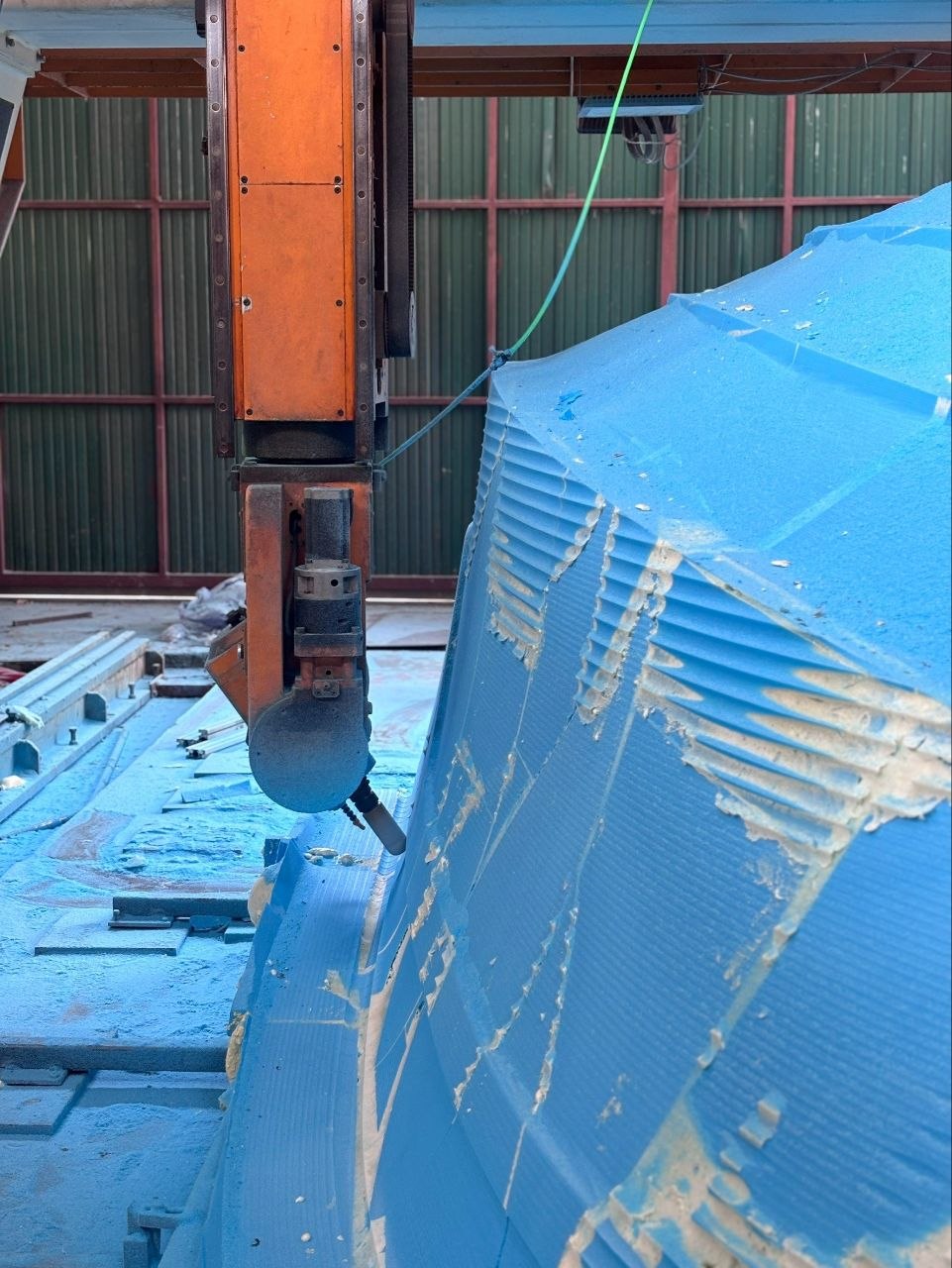 CNC cutting bow compound curve — layered foam visible